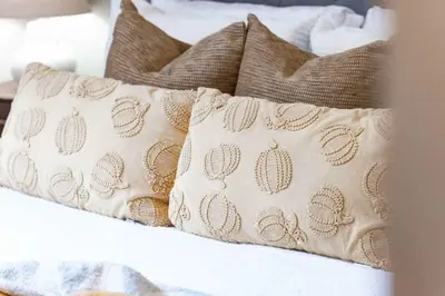 a group of pillows sitting on top of a bed at Modern Oasis Stylish 2BR Condo Near Attractions in Toronto