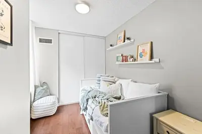 a white room with a bed and a window at Modern Oasis Stylish 2BR Condo Near Attractions in Toronto