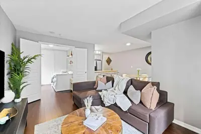 a living room with a couch and a table at Modern Oasis Stylish 2BR Condo Near Attractions in Toronto
