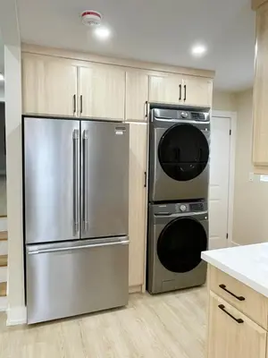 a kitchen with a stainless steel refrigerator and a dishwasher at 3 Bedroom Home Peaceful & Trendy in Brampton