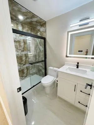 a bathroom with a toilet and a sink and a shower at 3 Bedroom Home Peaceful & Trendy in Brampton