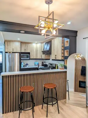 a kitchen with wooden cabinets and a bar with stools at Hamilton Ontario 2 BR Wi-Fi Workspaces Near Ottawa in Hamilton