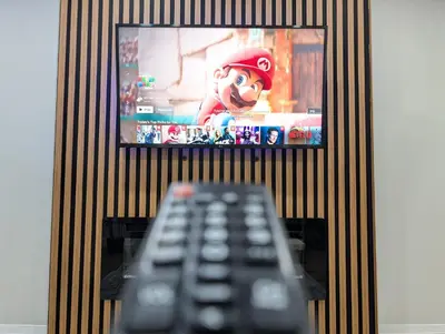 a remote control sitting in front of a tv at Hamilton Ontario 2 BR Wi-Fi Workspaces Near Ottawa in Hamilton