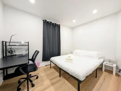 a bedroom with a bed and a desk and a computer at Hamilton Ontario 2 BR Wi-Fi Workspaces Near Ottawa in Hamilton