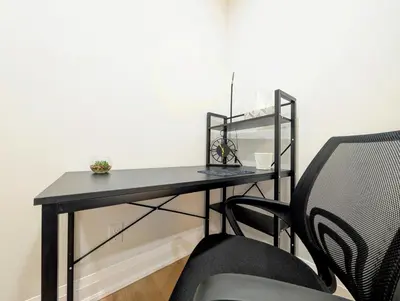 a black desk with a chair in a room at Hamilton Ontario 2 BR Wi-Fi Workspaces Near Ottawa in Hamilton