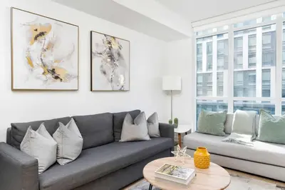 a living room with a couch and a table at Modern Waterfront Comfort Condo with City Views in Toronto