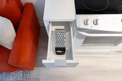 a remote control in a stand next to a couch at Modern & Stylish Comfort in the Heart of Toronto in Toronto