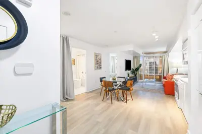 a living room with a table and a dining room at Modern & Stylish Comfort in the Heart of Toronto in Toronto