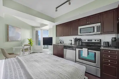 a kitchen with a bed in the middle of a room at Cozy Waterfront Studio plus Parking by the Bentway in Toronto