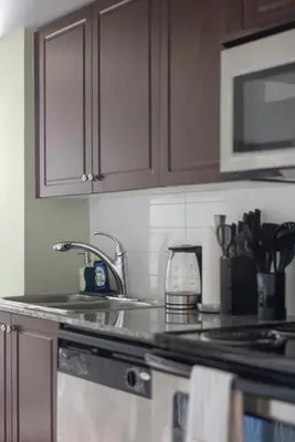 a kitchen counter with a sink and a microwave at Cozy Waterfront Studio plus Parking by the Bentway in Toronto