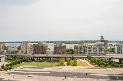 a view of a city with buildings and a freeway at Corner 2 Bedroom 2 Bathroom Condo Balcony Iceboat Terrace Downtown Toronto in Toronto