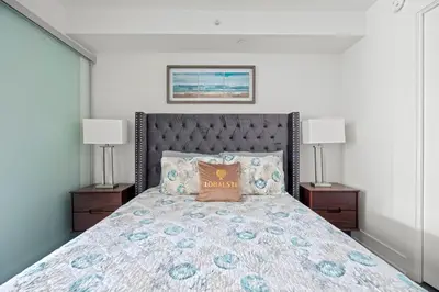 a bedroom with a large bed with two lamps at Modern 1BD Apartment with Balcony DT Toronto in Toronto