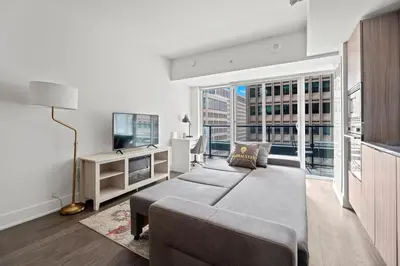 a living room with a couch and a tv at Modern 1BD Apartment with Balcony DT Toronto in Toronto