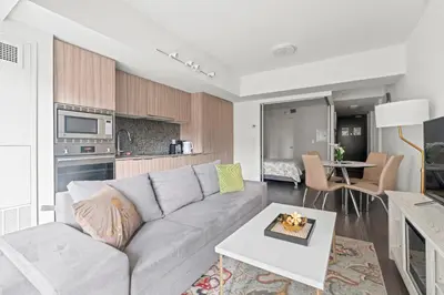 a living room with a couch and a table at Modern 1BD Apartment with Balcony DT Toronto in Toronto