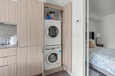 a kitchen with a washer and dryer in a room at Modern 1BD Apartment with Balcony DT Toronto in Toronto