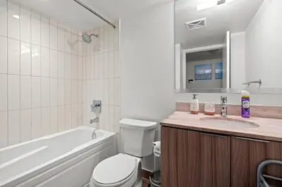 a bathroom with a tub and a toilet and a sink at Modern 1BD Apartment with Balcony DT Toronto in Toronto