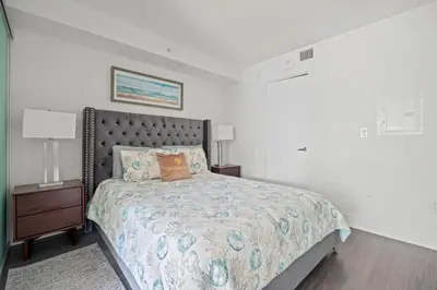 a bedroom with a bed and a night stand with two lamps at Modern 1BD Apartment with Balcony DT Toronto in Toronto