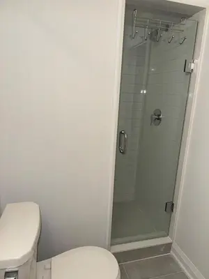 a bathroom with a toilet and a glass shower at Entire unit seprate entrance in Richmond Hill