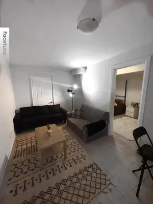 a living room with a couch and a table at Entire unit seprate entrance in Richmond Hill