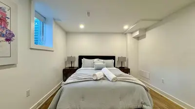 a bedroom with a large bed in a white room at Spacious and Luxurious 2BR Suite with Huge Windows in Mississauga