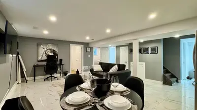 a living room with a table and a couch at Spacious and Luxurious 2BR Suite with Huge Windows in Mississauga