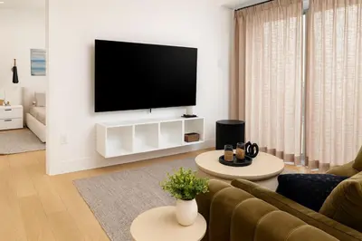 a living room with a flat screen tv on a wall at Stoney Lake Cottage with Private Dock by Leavetown Vacations in Crowes Landing