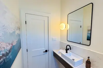 a bathroom with a sink and a mirror at Stoney Lake Cottage with Private Dock by Leavetown Vacations in Crowes Landing