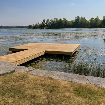 a wooden dock in the middle of a body of water at Stoney Lake Cottage with Private Dock by Leavetown Vacations in Crowes Landing