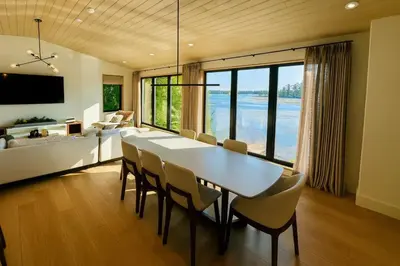 a dining room with a table and chairs and a couch at Stoney Lake Cottage with Private Dock by Leavetown Vacations in Crowes Landing