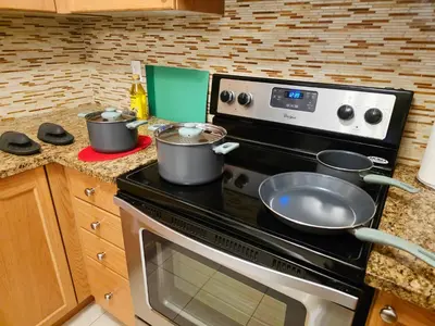 a kitchen with a stove with pots and pans on it at Semi-Private Townhouse - 3 Bedrooms - 4 beds - Free Parking, Wifi, Netflix in Toronto