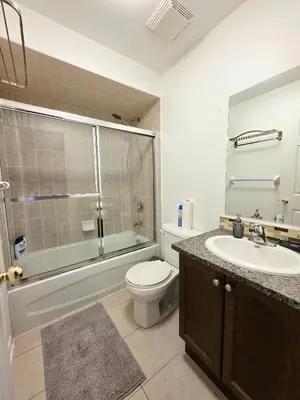 a bathroom with a toilet and a sink and a shower at Semi-Private Townhouse - 3 Bedrooms - 4 beds - Free Parking, Wifi, Netflix in Toronto