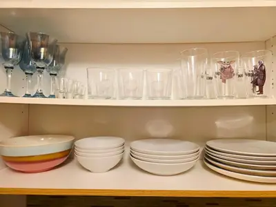 a shelf filled with plates and bowls and glasses at Semi-Private Townhouse - 3 Bedrooms - 4 beds - Free Parking, Wifi, Netflix in Toronto