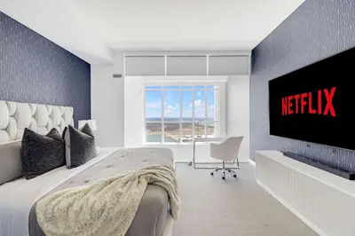 a bedroom with a bed and a tv on a wall at Sky-High Penthouse Breathtaking City Views in Toronto
