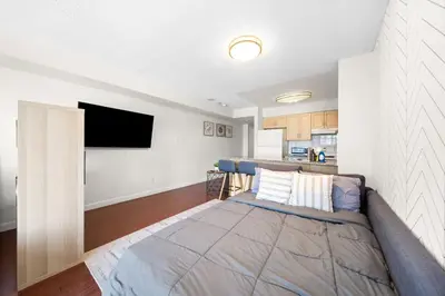 a bedroom with a bed and a tv on a wall at Downtown Toronto Studio Retreat in Toronto