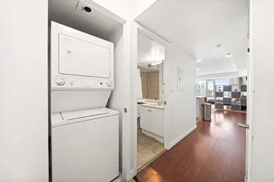 a kitchen with a white refrigerator in a room at Downtown Toronto Studio Retreat in Toronto