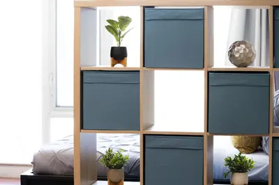 a shelving unit with blue doors in a room at Downtown Toronto Studio Retreat in Toronto
