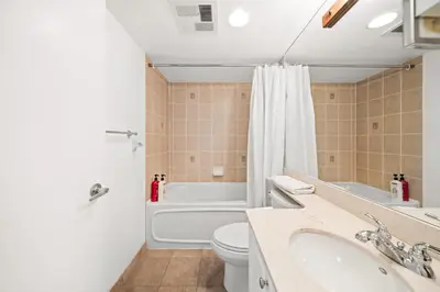a bathroom with a toilet and a tub and a sink at Downtown Toronto Studio Retreat in Toronto