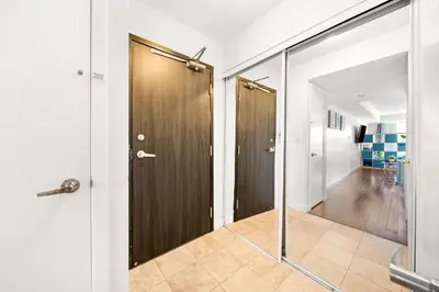 a hallway with two wooden doors and a walk in shower at Downtown Toronto Studio Retreat in Toronto