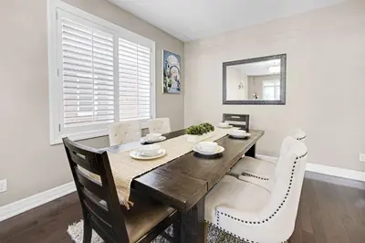 a dining room with a wooden table and chairs at Pool, King Bed, Patio with BBQ, Fall Hiking Nearby in Cambridge