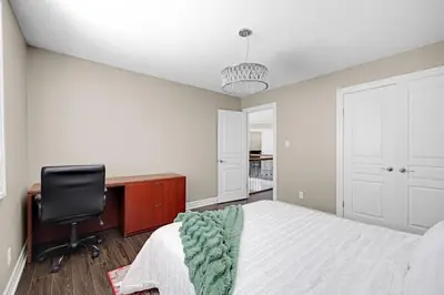 a bedroom with a bed and a desk and a chair at Pool, King Bed, Patio with BBQ, Fall Hiking Nearby in Cambridge