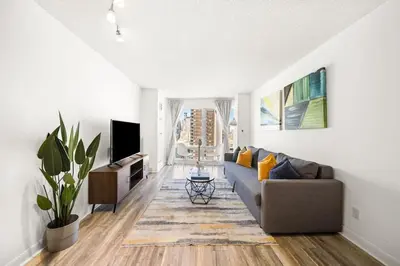 a living room with a couch and a tv at Chic 1BR Downtown Getaway w King Bed in Toronto