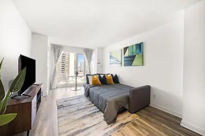a bedroom with a bed and a large window at Chic 1BR Downtown Getaway w King Bed in Toronto