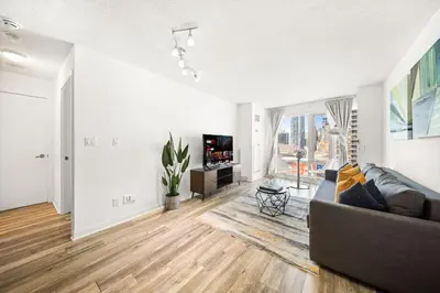 a living room with a couch and a television at Chic 1BR Downtown Getaway w King Bed in Toronto
