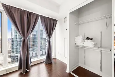 a room with a window with a view of a city at Yonge and Dun condo in Toronto