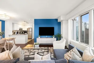 a living room with blue walls and a tv at Yonge and Dun condo in Toronto