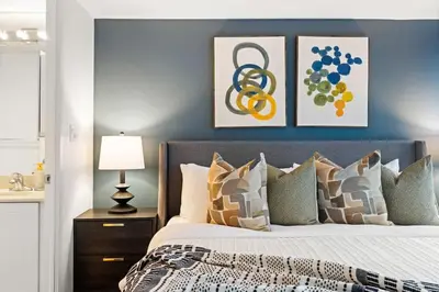 a bedroom with a king sized bed with two framed pictures at Yonge and Dun condo in Toronto