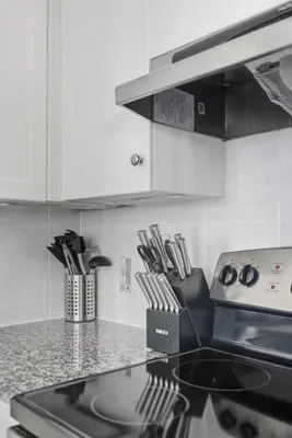 a kitchen with a stove and a counter top at Stylish 2BR Downtown Escape Prime Victoria Spot in Toronto