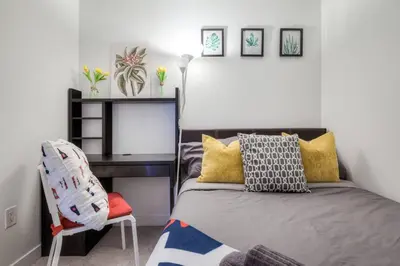 a bedroom with a bed and a desk and a chair at Modern 2 Bedroom plus Den Condo with Balcony Downtown Toronto in Toronto