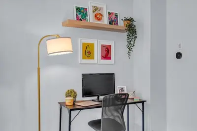 a desk with a computer and a chair at Chic Open-Concept 5 Beds Home by Airport and Highways in Brampton