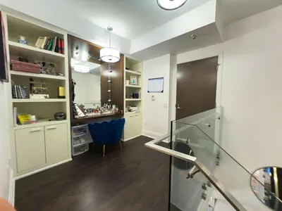 a kitchen with white cabinets and a blue chair at Luxury 2-Story loft in downtown in Toronto